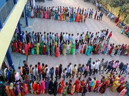 People lined up at booth for casting vote