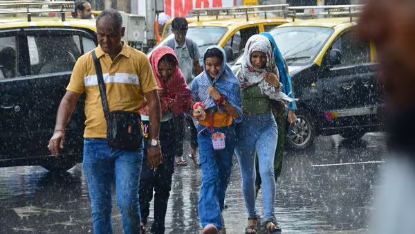 Mumbai road during monsoon with cloudy sky and wet streets.