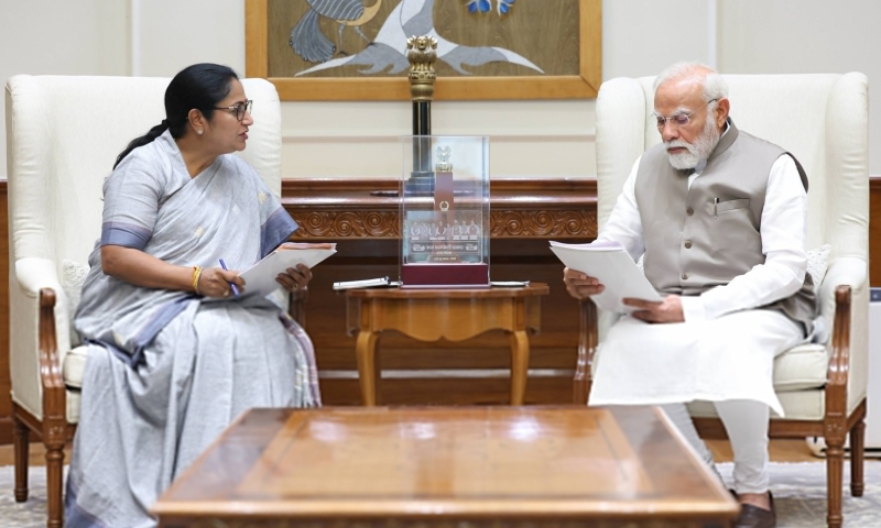 Delhi CM Rekha Gupta and PM Narendra Modi shaking hands in an office setting.