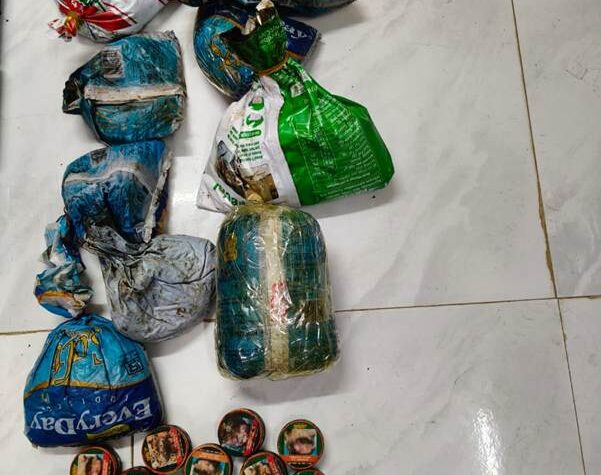  “Indian officers display ₹55 crore worth of heroin and cash seized in Manipur drug bust.”